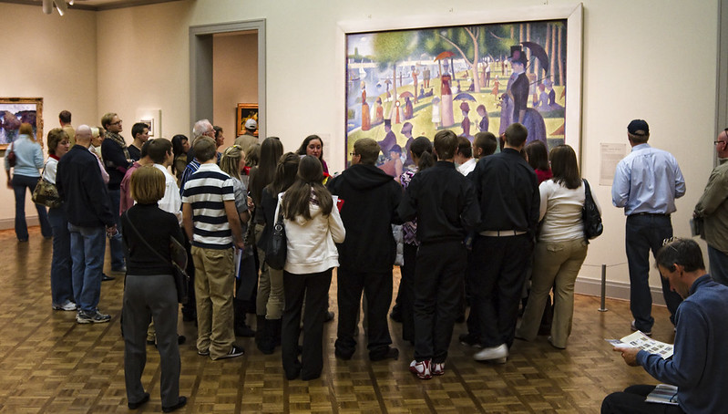 This is Georges Seurat’s pointillism masterpiece ‘A Sunday Afternoon on the Island of La Grande Jatte.’ It hangs in the Art Institute of Chicago and always has a crowd in front of it.